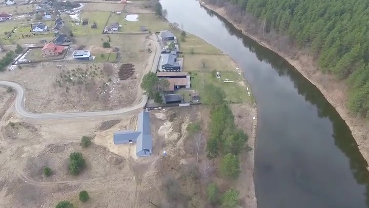 Flight Beyond River Over Small Town