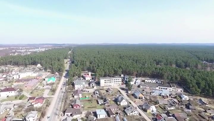 Flight Over Small Town Near Forest With Fast Rotation