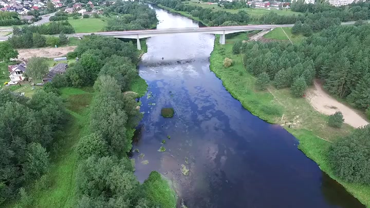 Flying Away From The Bridge Near River And Small Town In Distance